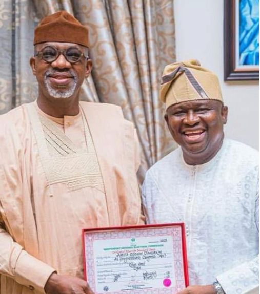Senator Adeola presenting his Certificate of Return to Prince Dapo Abiodun, Governor of Ogun State.